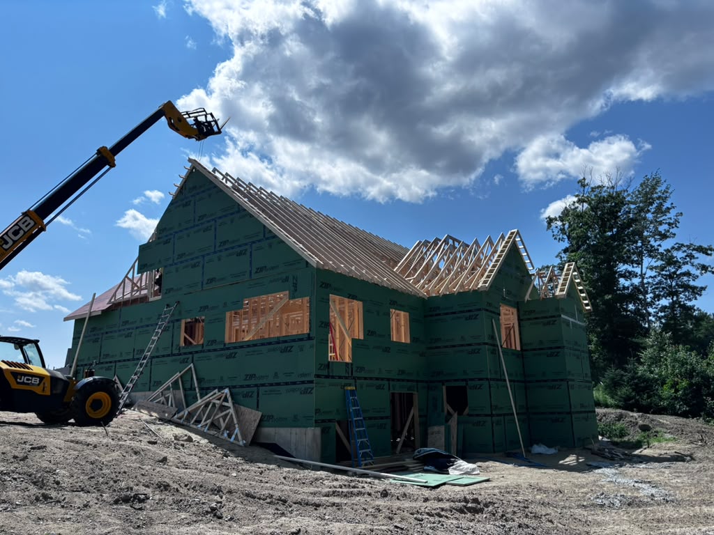 Roof truss installation with telehandler on site